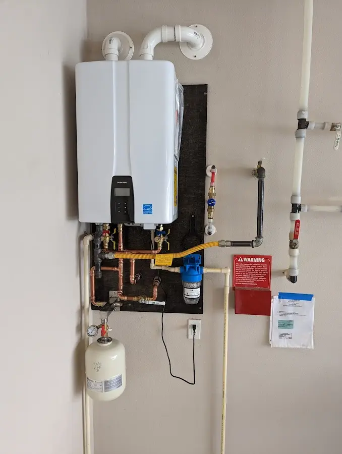 Professional plumber installing copper piping in a Naples Manor home